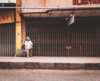 Full length of woman standing against building