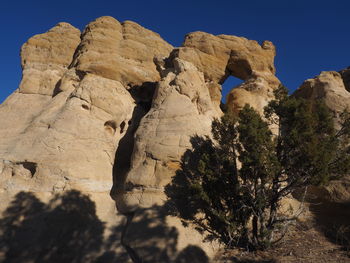 Low angle view of rock formation on land against sky