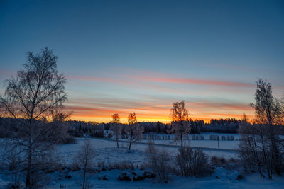 Scenic view of landscape against sky during winter