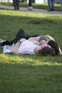 High angle view of woman relaxing on field