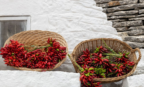Dried peppers in baskets on a wall in ostuni.
