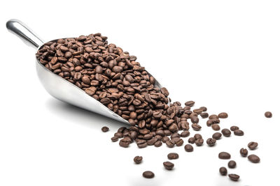 High angle view of coffee beans against white background