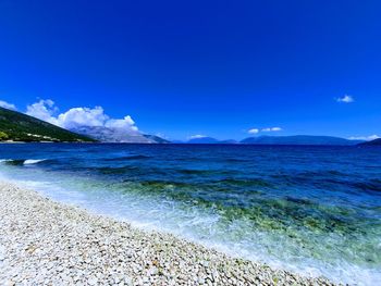 Scenic view of sea against blue sky