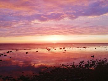 Scenic view of beach against sky during sunset