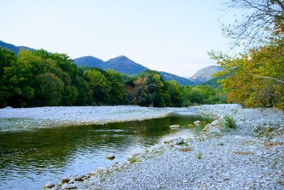 Scenic view of lake and mountains against sky