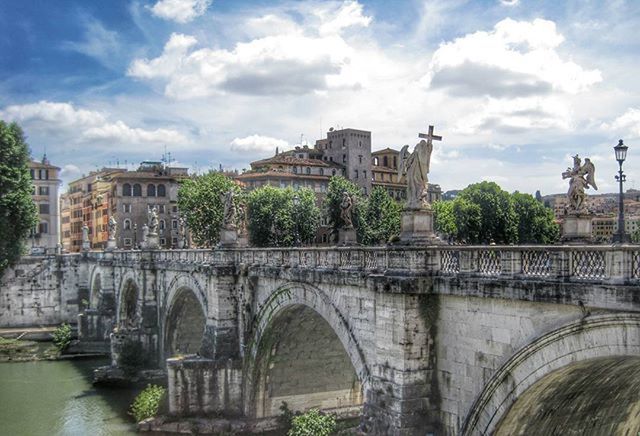 architecture, built structure, building exterior, sky, cloud - sky, water, bridge - man made structure, connection, arch, river, cloud, arch bridge, tree, cloudy, city, canal, bridge, day, transportation, building