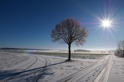 Scenic view of snow covered landscape against clear sky