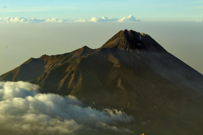 Scenic view of snowcapped mountains against cloudy sky