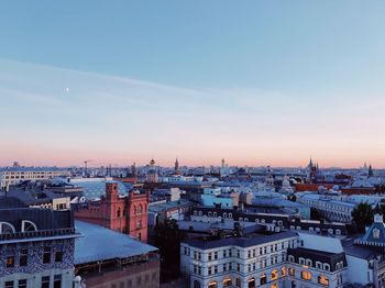 High angle view of buildings in city at sunset