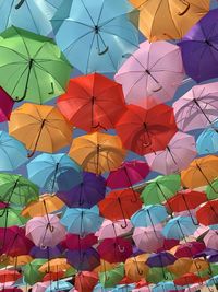 Low angle view of multi colored umbrellas hanging at market stall