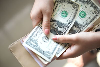 Close-up of hands holding currency