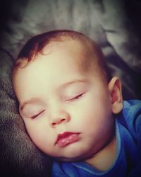 Portrait of cute boy sleeping on bed