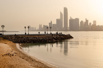 Abu dhabi skyline at sunrise. establishing shot.