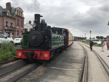 Train at railroad station against sky