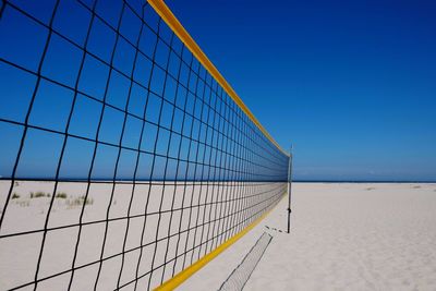 Scenic view of beach against clear blue sky