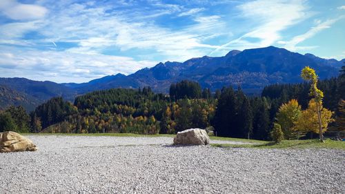 Scenic view of trees and mountains against sky