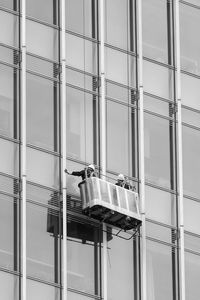 Low angle view of worker outside glass building