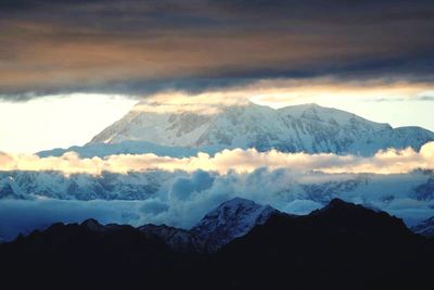 Scenic view of mountains against cloudy sky