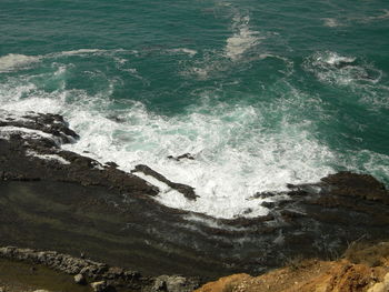 High angle view of waves splashing in sea