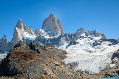 Scenic view of snowcapped mountains against clear blue sky