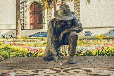 Statue against building in city