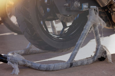 Close-up of bicycle parked on street in city