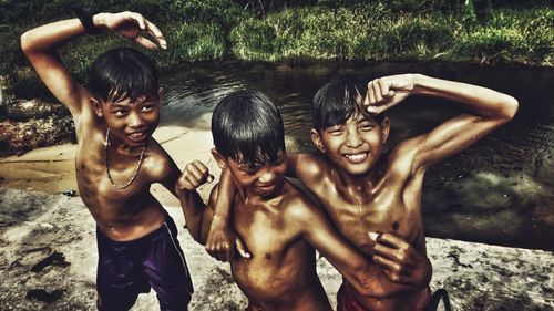 Full length of shirtless boy standing outdoors