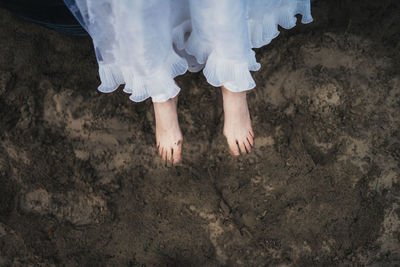 Low section of woman standing on beach