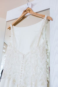 Close-up of clothes hanging against white wall