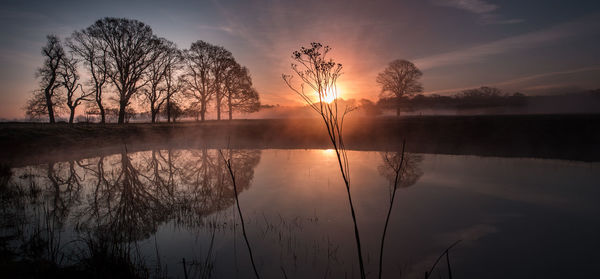 Scenic view of lake against sky during sunset