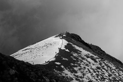 Low angle view of snowcapped mountain against sky