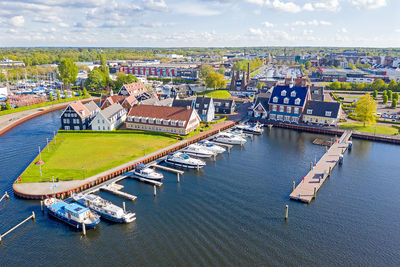 High angle view of townscape by river against sky