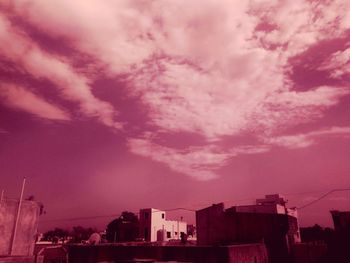 Low angle view of building against cloudy sky