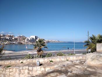 Scenic view of beach against clear blue sky