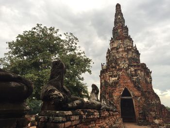 Low angle view of old ruins against cloudy sky