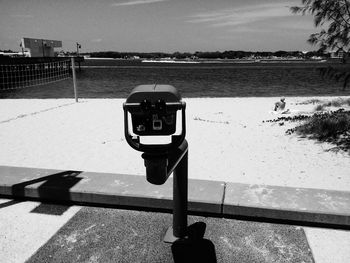 Coin operated binoculars in front of beach