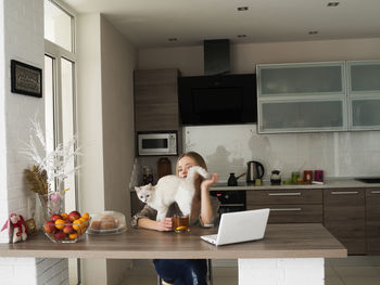 Woman working at home with cat