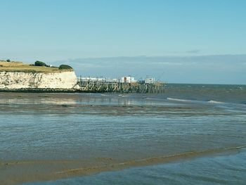 Scenic view of sea against blue sky