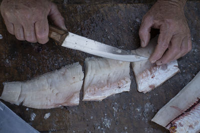 High angle view of man preparing fish