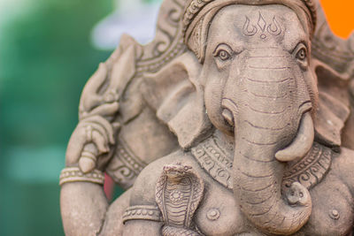 Close-up of buddha statue at temple