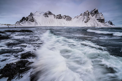 Scenic view of sea against sky during winter