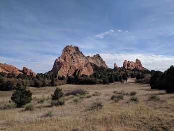 Rock formations on landscape against sky