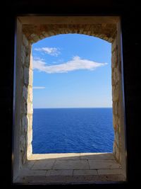 Blue sea seen through window