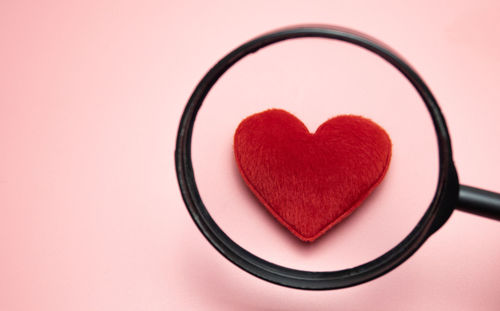 Close-up of heart shape over red background