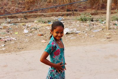 Portrait of smiling girl standing outdoors