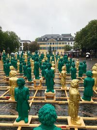 Rear view of statue against buildings in city