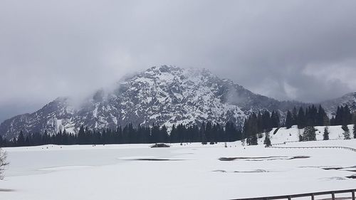 Scenic view of snow covered mountains against sky