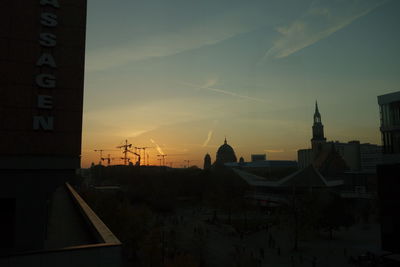 Buildings against sky at sunset