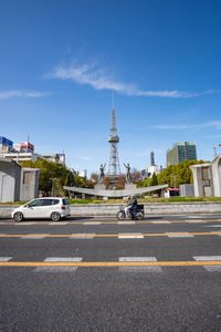 View of city street and buildings against sky