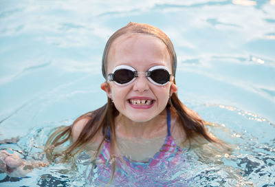 Portrait of young woman swimming in sea